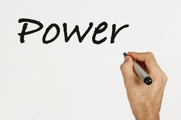 A man write 'Power' on white board with black marker. Space for text. 