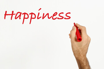 A man write 'Happiness' on white board with red marker. Space for text. 