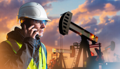 Man oil worker speaks on phone. Working petroleum deposit. Portrait of oil worker at sunset. Petroleum mining specialist. Oilman calls customer. Man energy resource extraction technologist