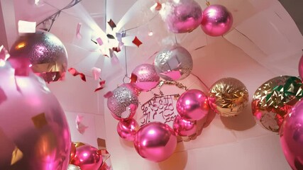 Close-up of a pink and gold balloon arrangement with sparkling details, celebrating a special event or party. video