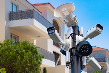 Video surveillance systems. Security cameras on pole. CCTV cameras near residential building....
