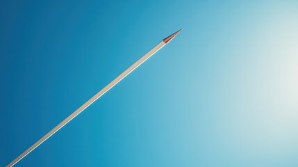 Fototapeta premium A track and field's javelin mid-air after release, outdoor setting with clear blue sky, Dynamic style