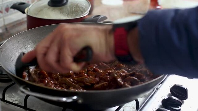 Cooking meat pieces with ketchup and mustard