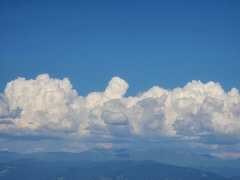 Cumulus Clouds Over Mountain Landscape