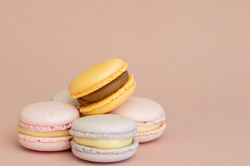 stack of delicious almond macaroons on plain background, delicate dessert