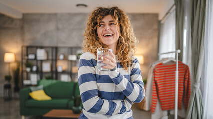 one woman beautiful young female at home with glass of water