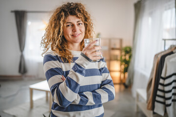 one woman beautiful young female at home with glass of water