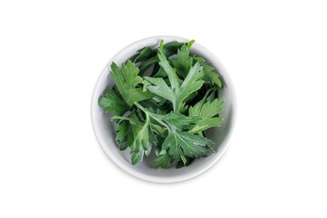 Fresh parsley leaves in a bowl on a white isolated background