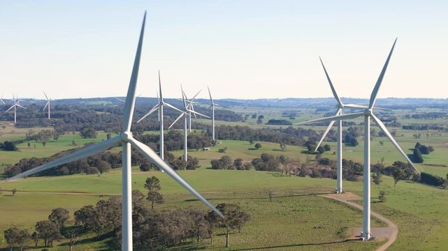 Aerial drone view of an array of large wind turbines at Biala and Gullen Range Wind Farm, Bannister in the Southern Tablelands region of New South Wales, Australia on a sunny day 