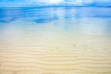 Beach sand surface and clear blue ocean waves in the coastline of Melekeok state, Palau, Pacific island