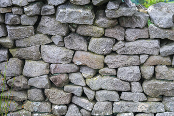 Dry grey stone wall, close up, can be used as a background
