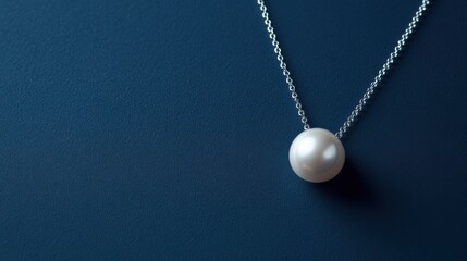 Single pearl necklace on a solid navy blue background