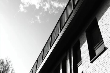 Fototapeta premium A Low-Angle View of a Brick Building with a Metal Railing