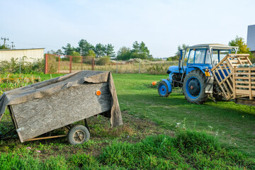 Tractor pulling crates filled with pumpkins and gourds for transport