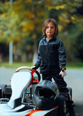 Brave Sportive Girl Standing Next to a Racing Kart. Little girl with an interest for motorsports...