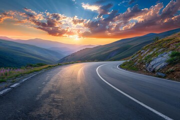 Mountain road at colorful sunset in summer. Beautiful curved roadway, rocks, stones, blue sky with clouds. Landscape with empty highway through the mountain pass in spring. Travel