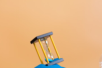 Hourglass is money sand of time, business blue sand in hourglass is adding more time in financial....