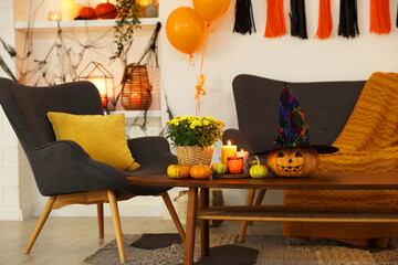 Room with stylish furniture decorated for Halloween