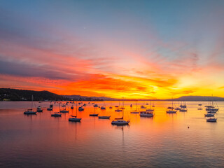 Naklejka premium Aerial sunrise waterscape with boats and high cloud