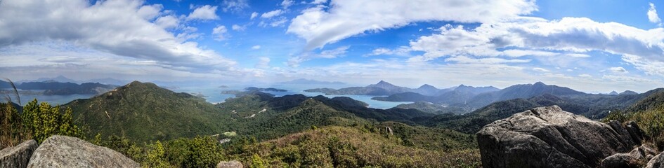 Naklejka premium Panoramic View of Mountainous Landscape with Blue Sky and Clouds, Hong Kong