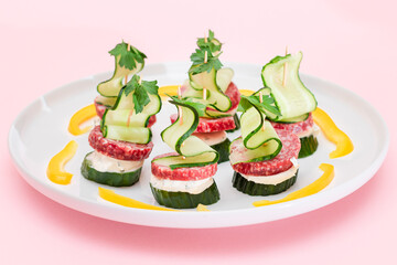 Canapes without Bread with Salami, Cucumber, Greens and Cream Cheese on White Plate. Easy Breakfast. Diet Food. Quick and Healthy Sandwiches. Healthy Snacks with Tasty Fillings