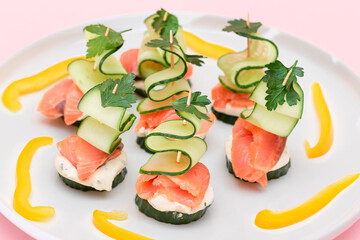 Canapes without Bread with Fresh Salmon, Cucumber and Cream Cheese on White Plate. Easy Breakfast. Diet Food. Quick and Healthy Sandwiches. Healthy Snacks with Tasty Fillings