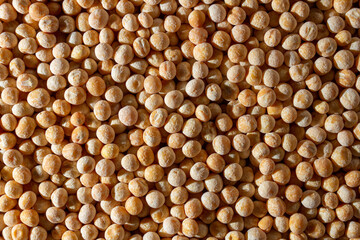 Uncooked Yellow Polished Peas Background. A Culinary Canvas of Dry Yellow Peas, Creating a Lively and Textured Background for Gourmet Cooking. Scattered Raw Polished Peas. Healthy Eating Ingredients