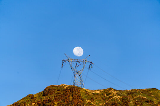 500kV transmission towers and full moon in the Andes mountain range