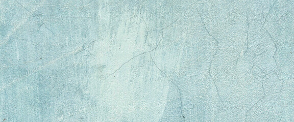 Close-up shot of a light blue concrete wall with a fine textured surface and subtle cracks. Classic retro texture for poster banner background and other digital needs.