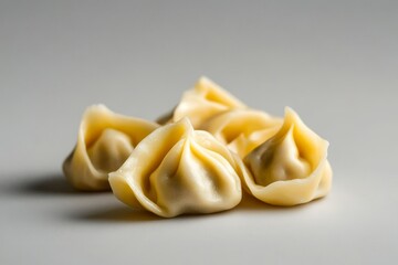 Fresh dumplings arranged on a gray surface, ideal for culinary use.