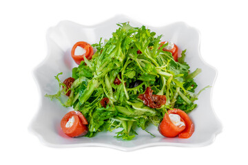 Fresh salad with arugula, salmon, cream cheese and sun-dried tomatoes on white background