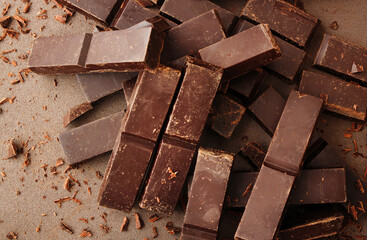 Creative layout made of dark chocolate on the dark background. Flat lay. Food concept. Macro concept. 