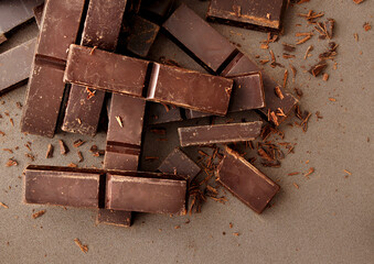 Creative layout made of dark chocolate on the dark background. Flat lay. Food concept. Macro...
