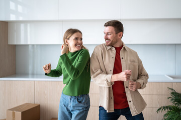 Excited family dancing, ready to unpack boxes in new home, moving in together. Couple with mortgage loan, fresh start and family bonding, teamwork, organizing space, building future, new memories