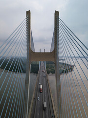 View of Phu My Bridge in Ho Chi Minh City Vietnam during the day. Symmetrical view directly along the traffic lanes and cables in vertical format.
