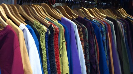 A Collection of Vibrant and Colorful Knit Sweaters Beautifully Displayed on Hangers