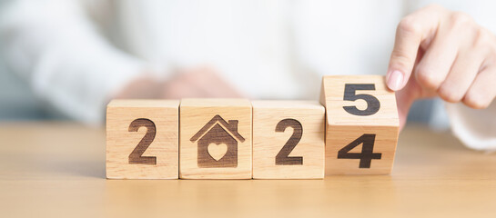 2024 end year to Happy New Year 2025 with Home and Heart block. Property investment, House Mortgage, Real Estate tax, homeless, donation, Financial and happy family concepts