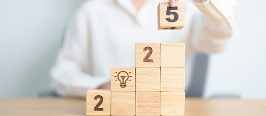 2025 year block with lightbulb. Business Idea, Creative, Thinking, brainstorm, Goal, Resolution,...