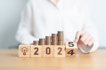 2024 end year to Happy New Year 2025 with Coins stack and lightbulb icon. Business Idea, Creative, Thinking, brainstorm,Money, Budget, investment, financial, savings and New Year Resolution concept