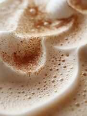 Creamy pumpkin spice latte topped with whipped cream and cinnamon, macro view