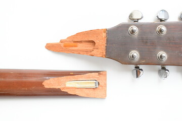 part of broken wood acoustic guitar isolated on white background