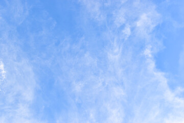beautiful blue sky and white fluffy group of clouds with sunrise in the morning, natural background