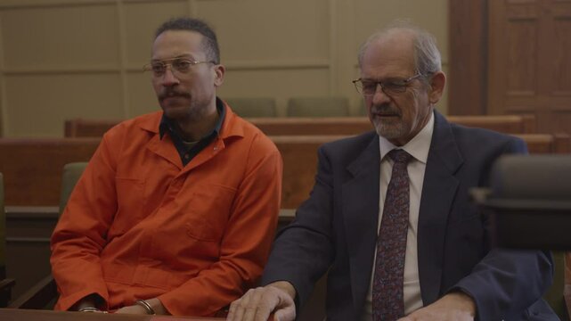 Lawyer and client in court room side by side