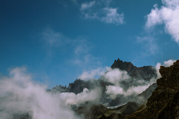 Aiguille du Midi top with clouds and blue sky cable station on way to Mont Blanc