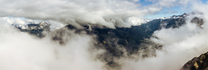 Top view through clouds on valley under Mont Blanc, france normal way to top