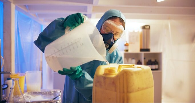 Person, liquid and drugs at illegal lab for production, jug and bottle with gas mask, hazard or night. Underground factory, plant and ppe for process, fluid or narcotic manufacturing for distribution
