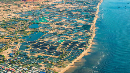 Aerial view of the prawn farm with aerator pump in front of Ninh Phuoc, Ninh Thuan, Vietnam. The...