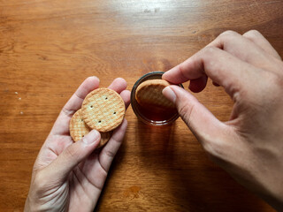 various kinds of biscuits that are usually eaten at breakfast accompanied by a glass of hot coffee on a white plate