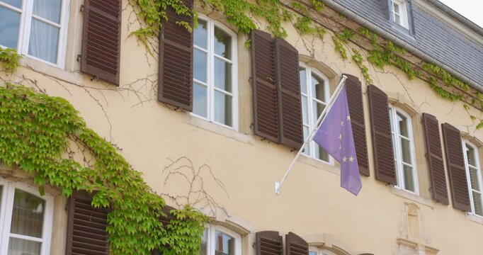 The flag of the European Union flies on the facade of a building in the village of Schengen.