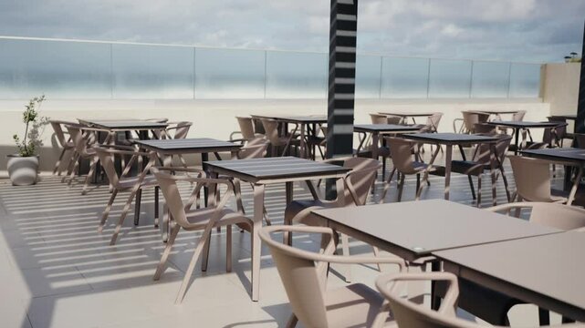 Empty rooftop cafe with modern furniture under a sunny sky. Perfect location for a relaxing outdoor meal with a scenic view. Ideal for restaurants, hospitality, and leisure concepts. chairs on terrace